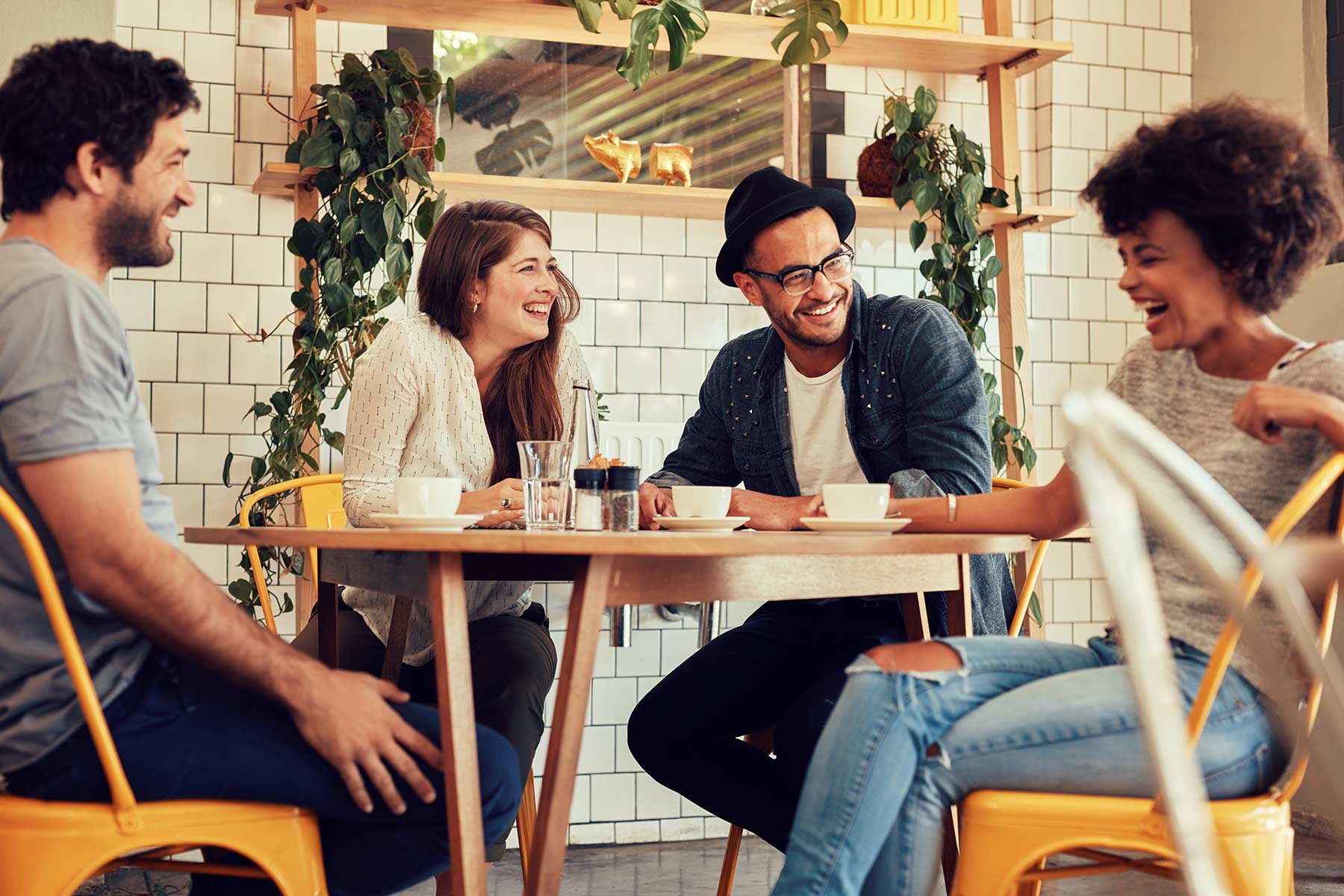 Friends conversing around a coffee shop table
